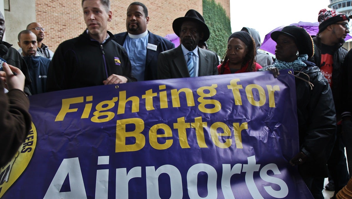Airport workers, union members and officials protest working conditions at an airport terminal Wednesday. (Kimberly Paynter/WHYY)