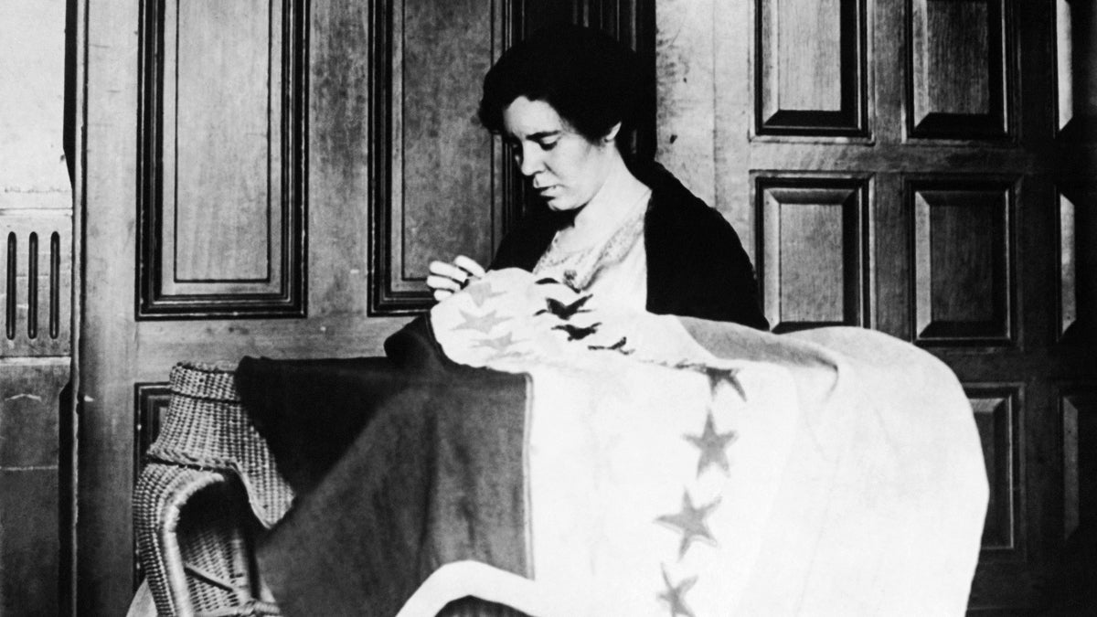  Alice Paul, chairwoman of the Nation Women's Party, takes up needle and thread to put the last stitch in the suffrage banner (c. 1932) which now has 36 stars representing the 36 states that ratified the 19th Amendment. (AP Photo) 