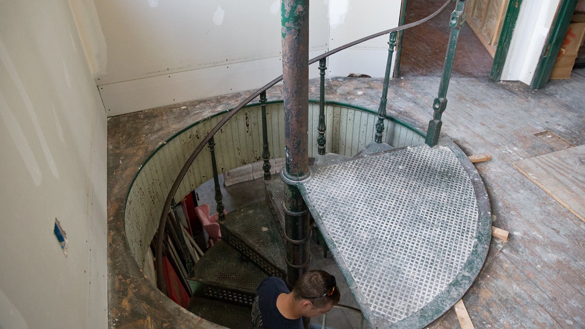  Jason Lloyd, a Harrisburg firefighter makes his way down the spiral staircase at the Allison Hook and Ladder firehouse. He's been restoring the Harrisburg firehouse built more than 100 years ago since 2010.  (Lindsay Lazarski/WHYY) 
