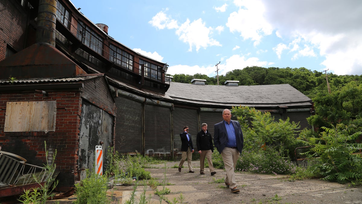 RIDC President Don Smith (right) and Tim White (center) say they’re eager to see development finally begin across the 178-acre LTV Steel Hazelwood site in southeast Pittsburgh. (Megan Harris/WESA)