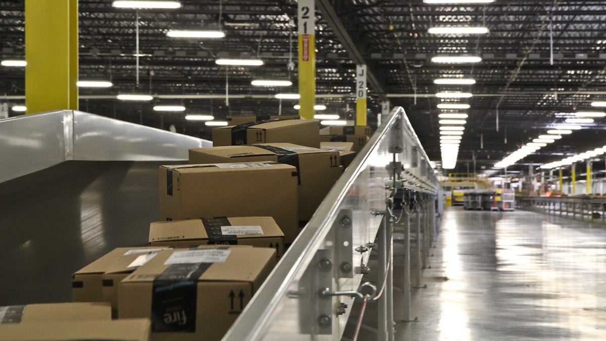  Packages move down a conveyer belt at Amazon's Fulfillment center in New Castle, Del. (Kimberly Paynter/WHYY) 