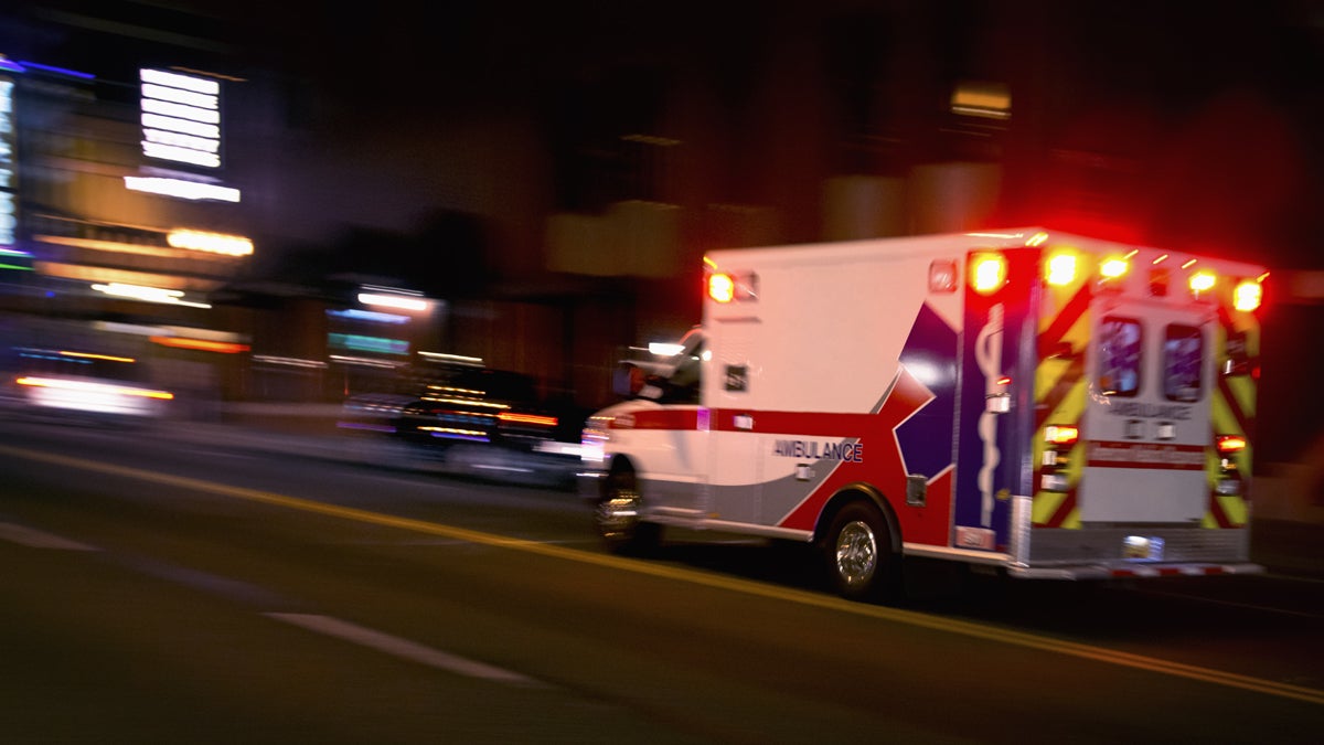  An ambulance speeds through traffic at night. (<a href=
