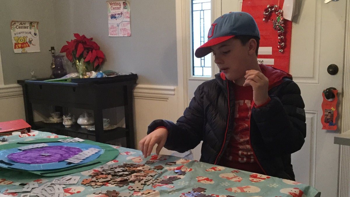  Anthony Burke takes a puzzle break from his applied behavioral analysis - or ABA therapy - in his dining room. (Kyrie Greenberg/ for NewsWorks) 