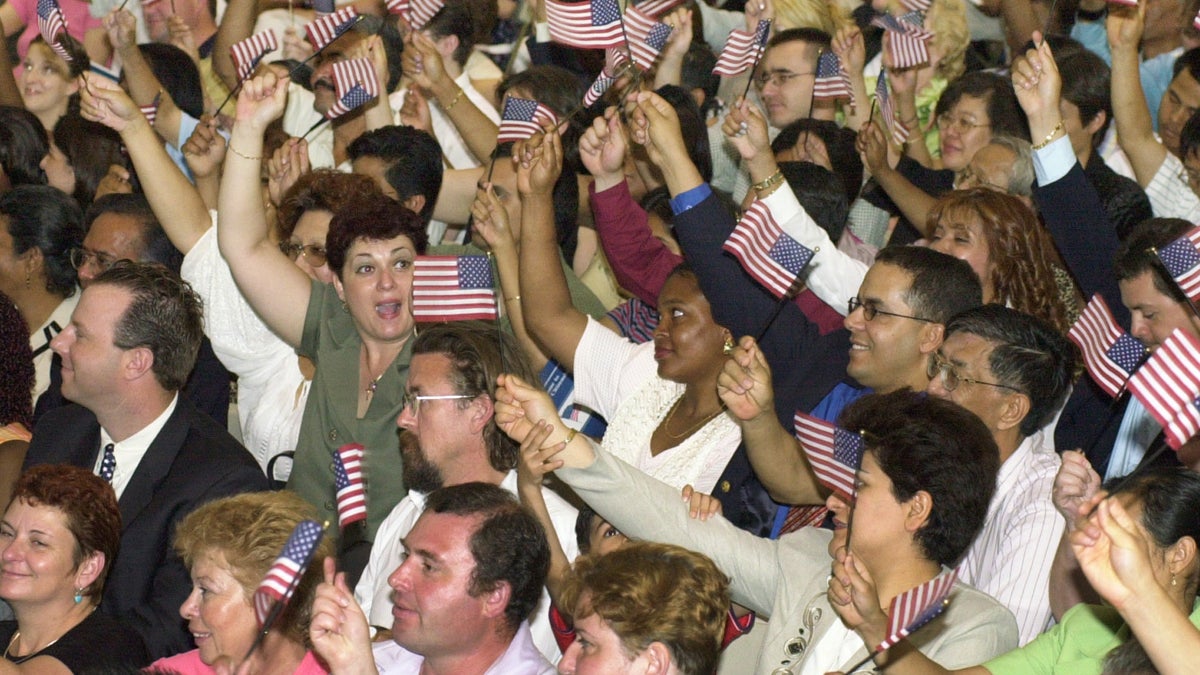  In this file photo, immigrants about to be sworn in as new U.S. citizens wave flags during the beginning of the ceremony sponsored by the Philadelphia Continental Chapter of Sons of the American Revolution in Philadelphia.(AP file photo/ Mark Stehle) 