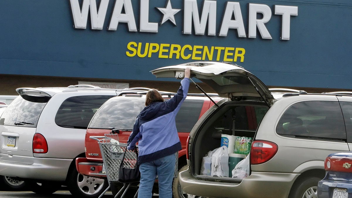  A shopper at a Walmart in North Fayette, Pennsylvania, loads her purchases into her car. The Pennsylvania Supreme Court has ruled that Walmart stores in Pennsylvania owe back pay and damages to tens of thousands of employees. (AP file photo) 