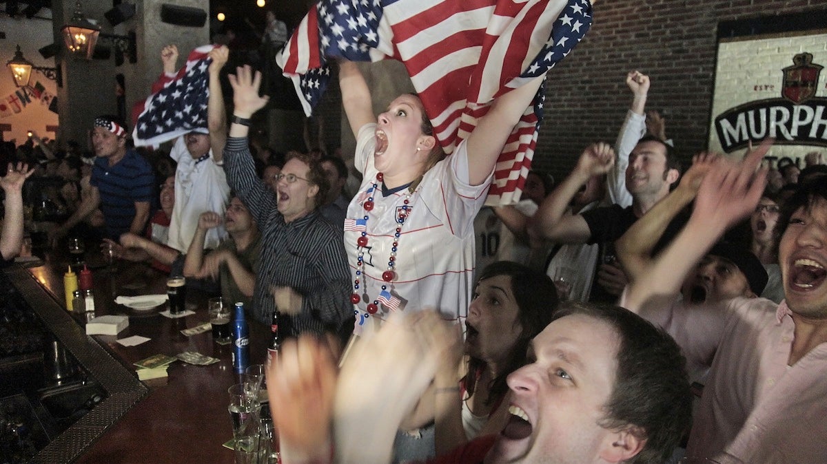  United States soccer fans react after the U.S. scored their second goal against Slovenia as they watch a live broadcast of the World Cup game at Stout's bar in New York on Friday, June 18, 2010. (Photo/Bebeto Matthews) 