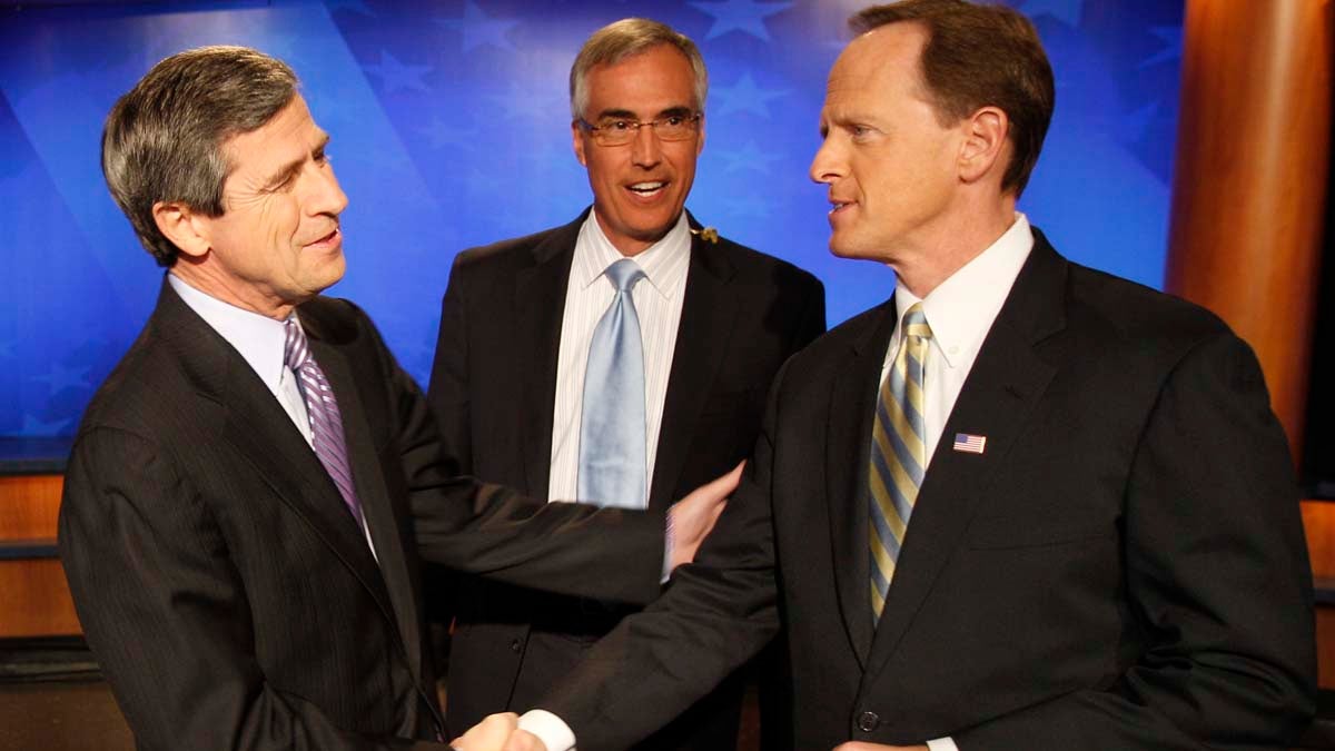  Pennsylvania Senate candidates Democratic Rep. Joe Sestak, D-Pa., left, and Republican Pat Toomey, shake hands in front of moderator David Johnson before a debate broadcast live from a television studio in Pittsburgh in October 2010. (AP file photo) 