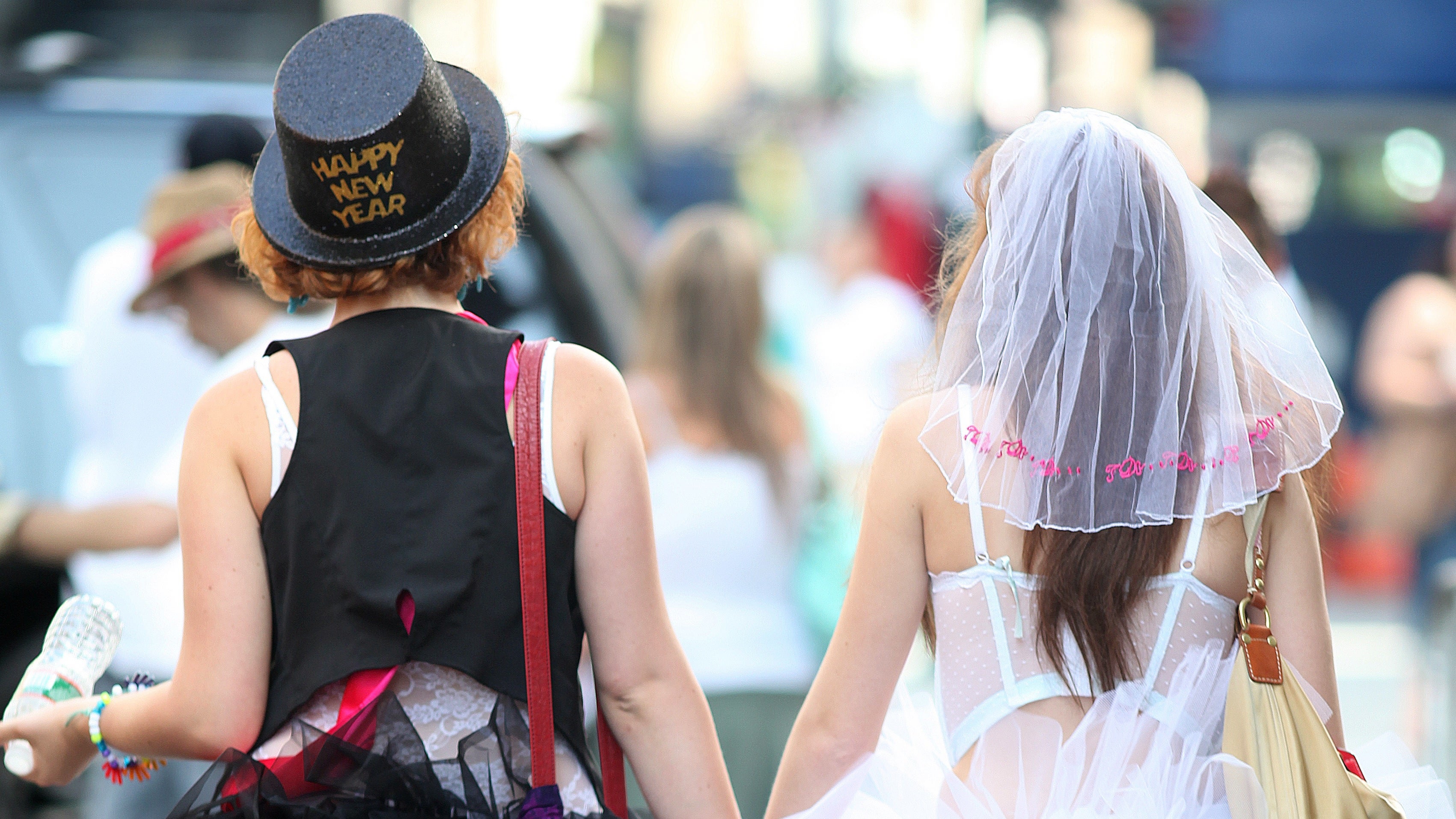  Two women dressed as brides hold hands before the start of the annual Gay Pride parade in New York. (AP Photo/Chelsea Matiash, file) 