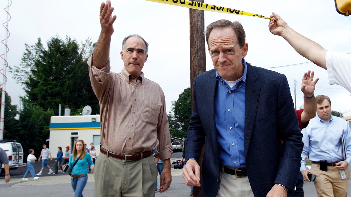  U.S. Sens. Bob Casey, left, and Pat Toomey say they have worked together on a number of issues, including this trip to inspect flooding damage in 2011. (AP file photo) 