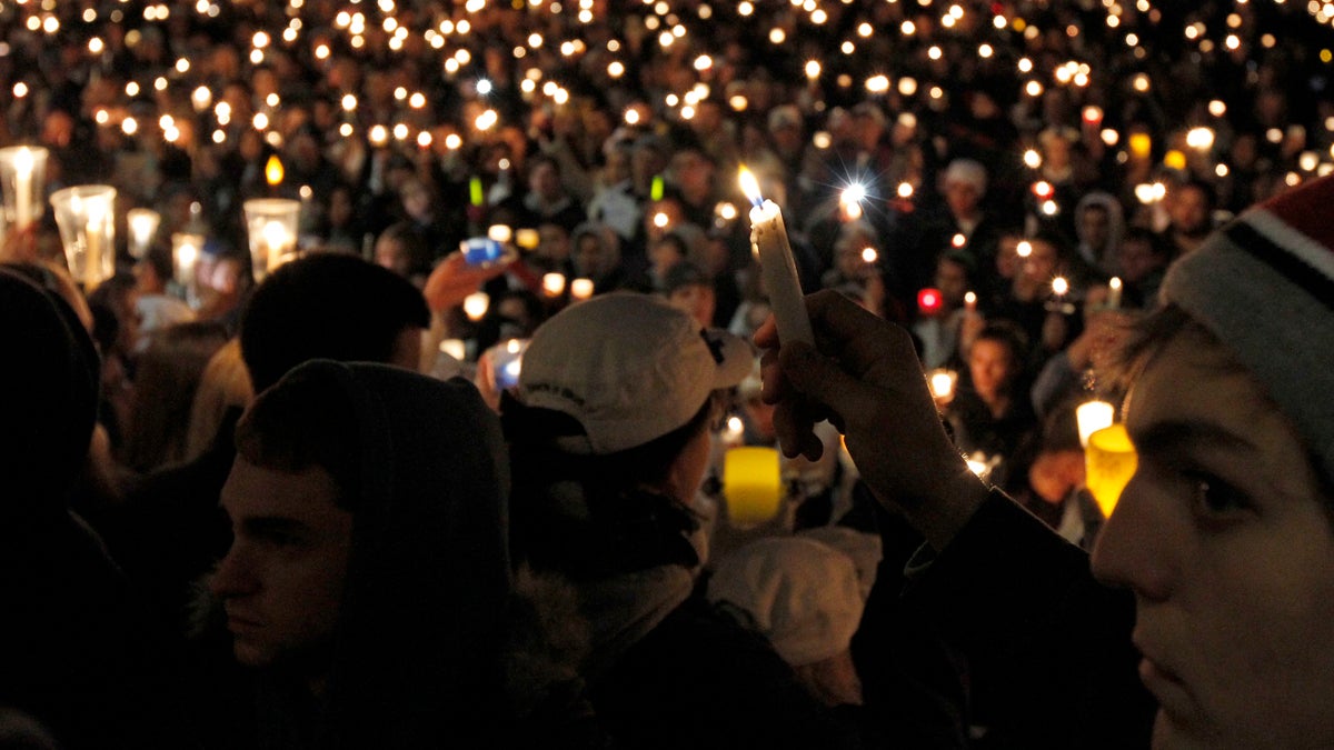  People hold a candlelight vigil to support sex abuse victims in front of the Old Main building on the Penn State Campus in November 2011 in State College, Pa. The state  Senate will take up a measure to reduce the size of Penn State's Board of Trustees, thereby responding to criticisms of how the university handled the Jerry Sandusky child sex abuse case.  (AP Photo/Alex Brandon) 