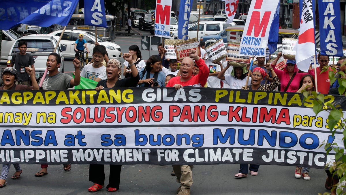  Protesters shout slogans as they march near the Presidential Palace in Manila to call on Philippine President Benigno Aquino III to focus on 