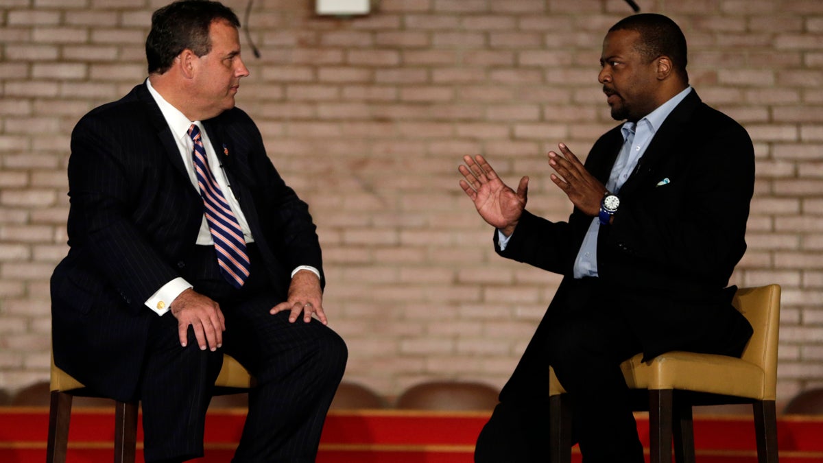  New Jersey Gov. Chris Christie, left, talks with New Hope Baptist Church Pastor Joe Carter during a summit on about drug addiction in Newark, New Jersey. (AP Photo/Julio Cortez) 
