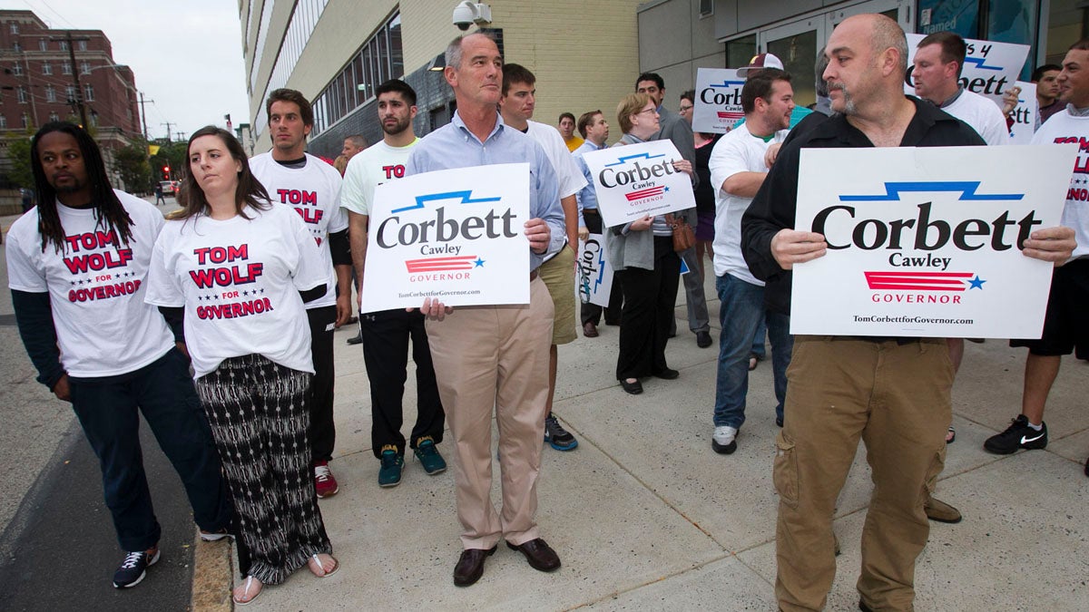  Making their sentiments known, supporters for Gov. Tom Corbett and candidate Tom Wolf gather early this month in Philadelphia as the candidates debate at 