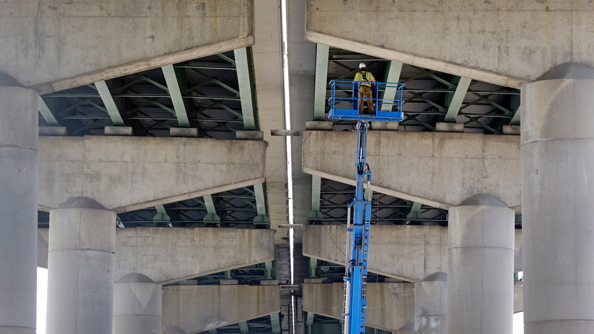  A worker inspects the underside of the Interstate 495 bridge over the Christina River near Wilmington, Del., Tuesday after it was closed due to the discovery of four tilting support columns. The closure created heavier-than-normal traffic conditions for motorists on Interstate 95, a major East Coast artery. The bridge normally carries about 90,000 vehicles a day. (AP photo/Patrick Semans 