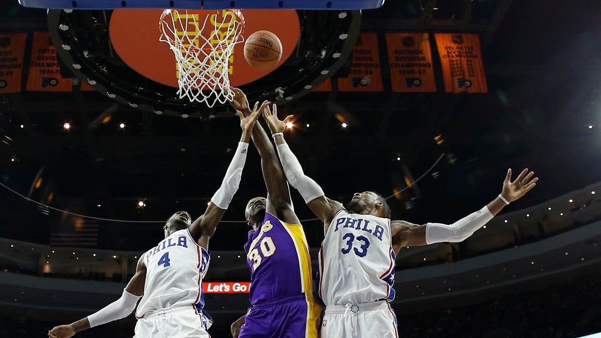 Philadelphia 76ers' Nerlens Noel (4) and Robert Covington (33) leap for a rebound against Los Angeles Lakers' Julius Randle (30) during the second half of an NBA basketball game