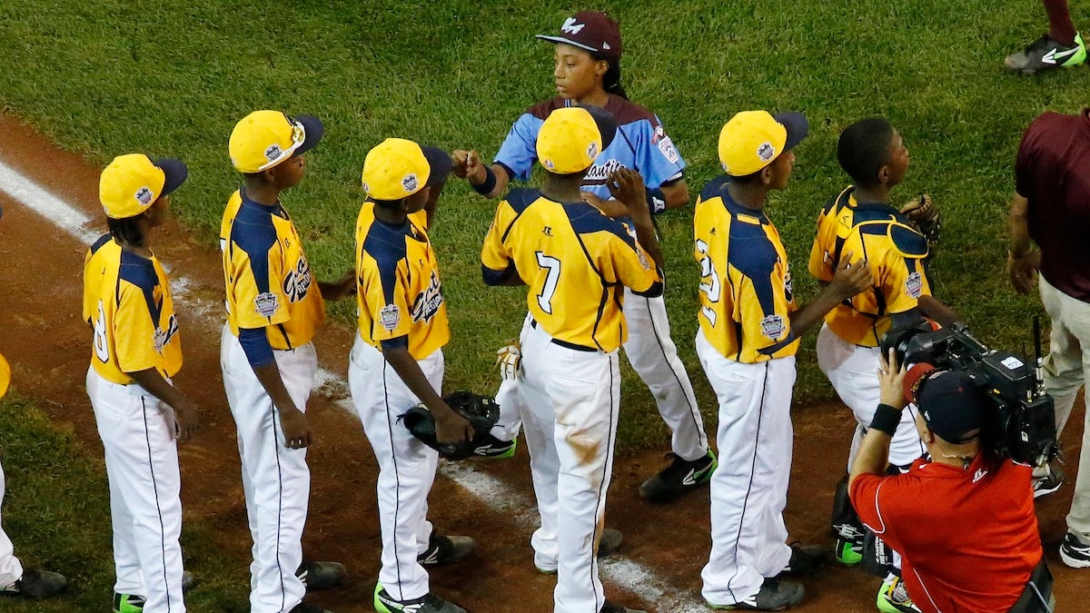  Philadelphia's Mo'ne Davis, top center, shakes hands with the players from the Chicago team after Philadelphia lost 6-5 in an elimination baseball game at the Little League World Series tournament. (AP Photo/Gene J. Puskar) 