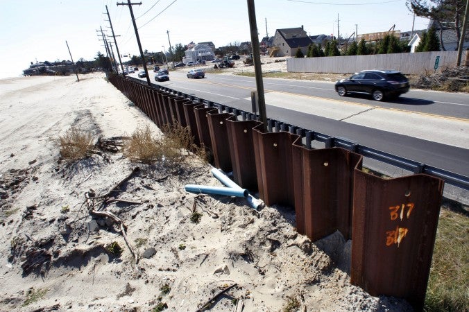  In this Oct. 13, 2013 photo, a huge steel seawall, sunken deep into the ground, is seen on the ocean side, along Route 35, in Mantoloking, N.J., in the area that was breached from the Atlantic Ocean to the Barnegat Bay a year ago during Superstorm Sandy. (AP Photo/Mel Evans) 