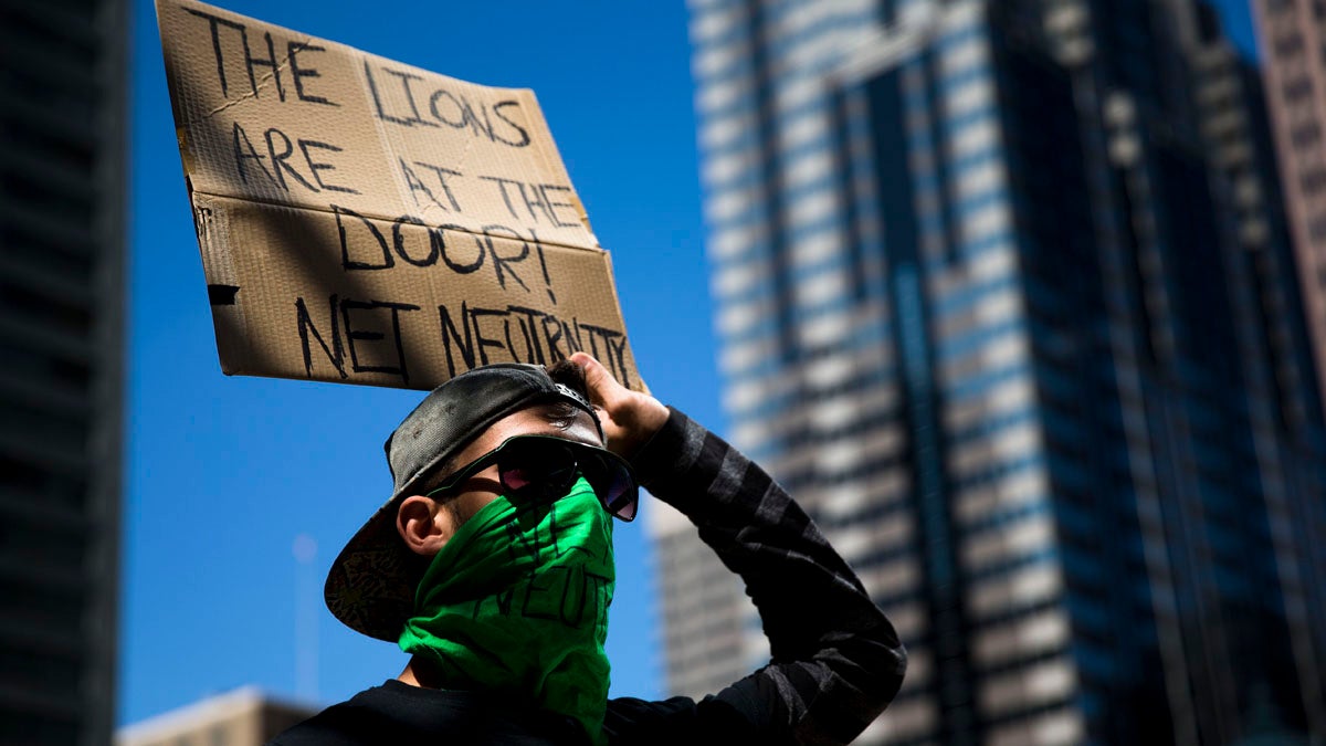  A protester demonstrates across the street from the Comcast Center in Philadelphia in September. At a  similar demonstration Thursday night, protesters called for further Federal Communications Commission regulation of Internet traffic to support 'net neutrality.' (AP Photo/Matt Rourke) 