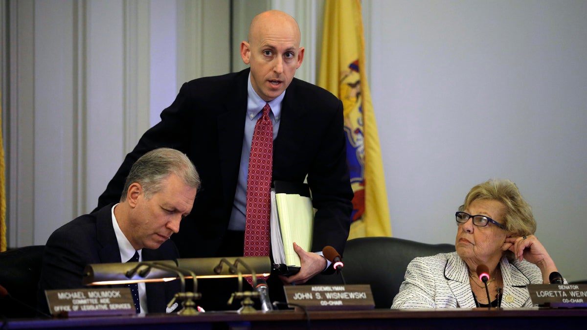  N.J. Assemblyman John S. Wisniewki, left, Sen. Loretta Weinberg, right,  listen as Reid Schar, special counsel to the Assembly committee, answers a question in Trenton, N.J., Tuesday, June 3, 2014.  (AP Photo/Mel Evans) 