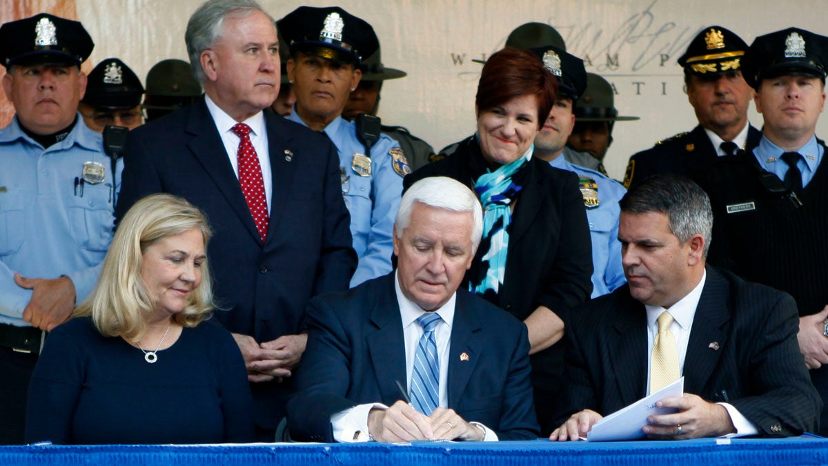  Gov. Tom Corbett, center, signs the law last month as Maureen Faulkner, widow of police Officer Daniel Faulkner, and Pa. state Rep. Mike Vereb look on. Tuesday Oct. 21, 2014 in Philadelphia. Corbett said the measure was intended to curb the 