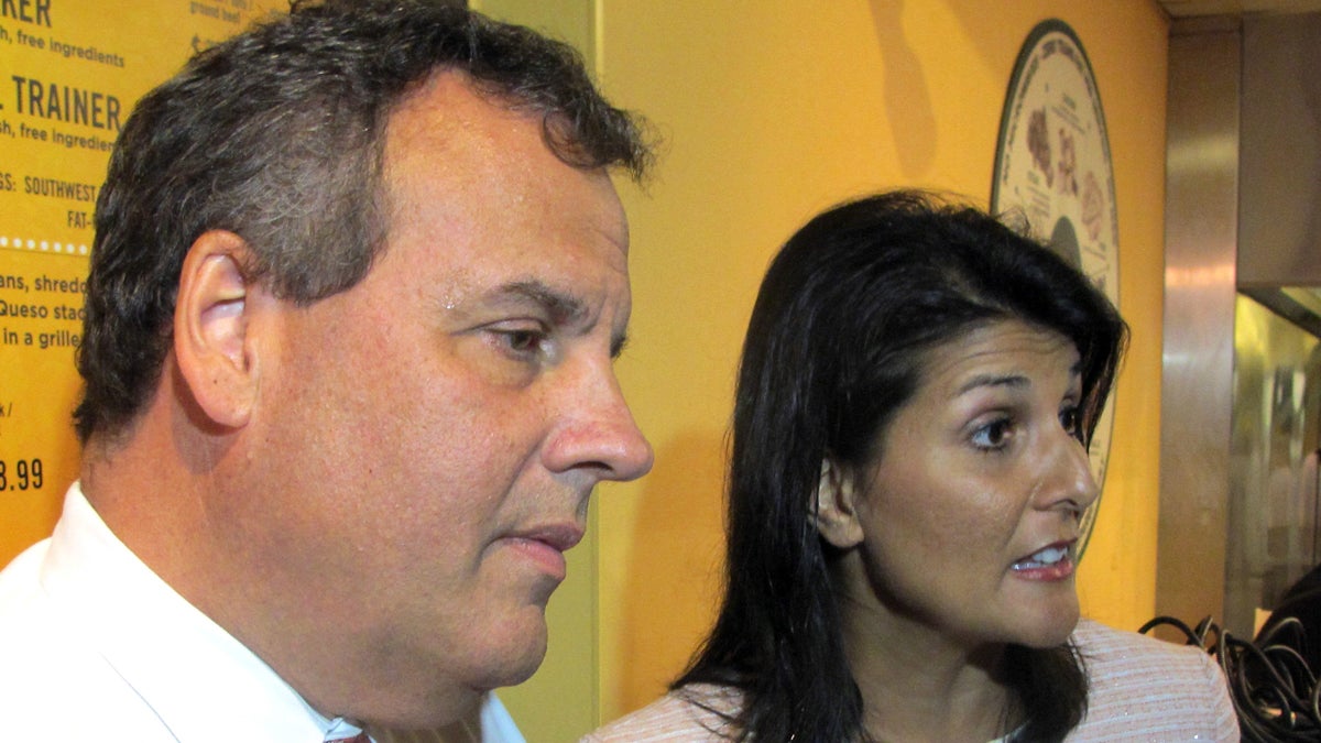  New Jersey Gov. Chris Christie and South Carolina Gov. Nikki Haley answer questions in Charleston. Christie's frequent travels and all the talk of a presidential bid have affected his job performance, N.J. voters said in poll released Wednesday. (Bruce Smith/AP) 