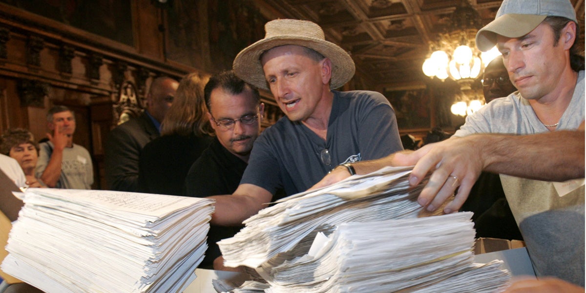  Political activist Gene Stilp, center, piles a stack of petitions bearing 129,000 signatures of taxpayers requesting a repeal of the legislative pay raise on a table in Pennsylvania Gov. Ed Rendell's reception room in Harrisburg in 2005. Stilp has filed a complaint with the Pennsylvania Supreme Court Disciplinary Board in light of criminal charges filed against Attorney General Kathleen Kane  last week. (AP file photo) 