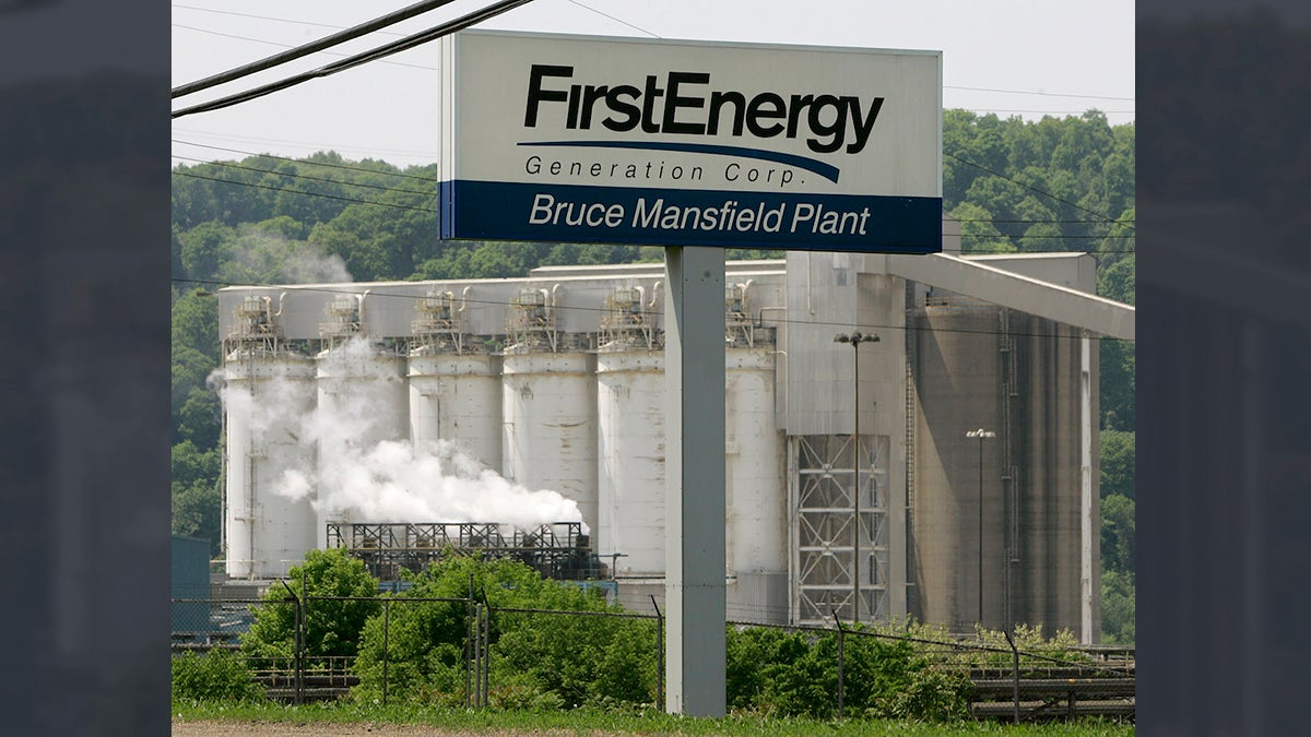 A portion of FirstEnergy Corporation's Bruce Mansfield electricity generating plant is seen behind the sign at the main gate in Shippingport
