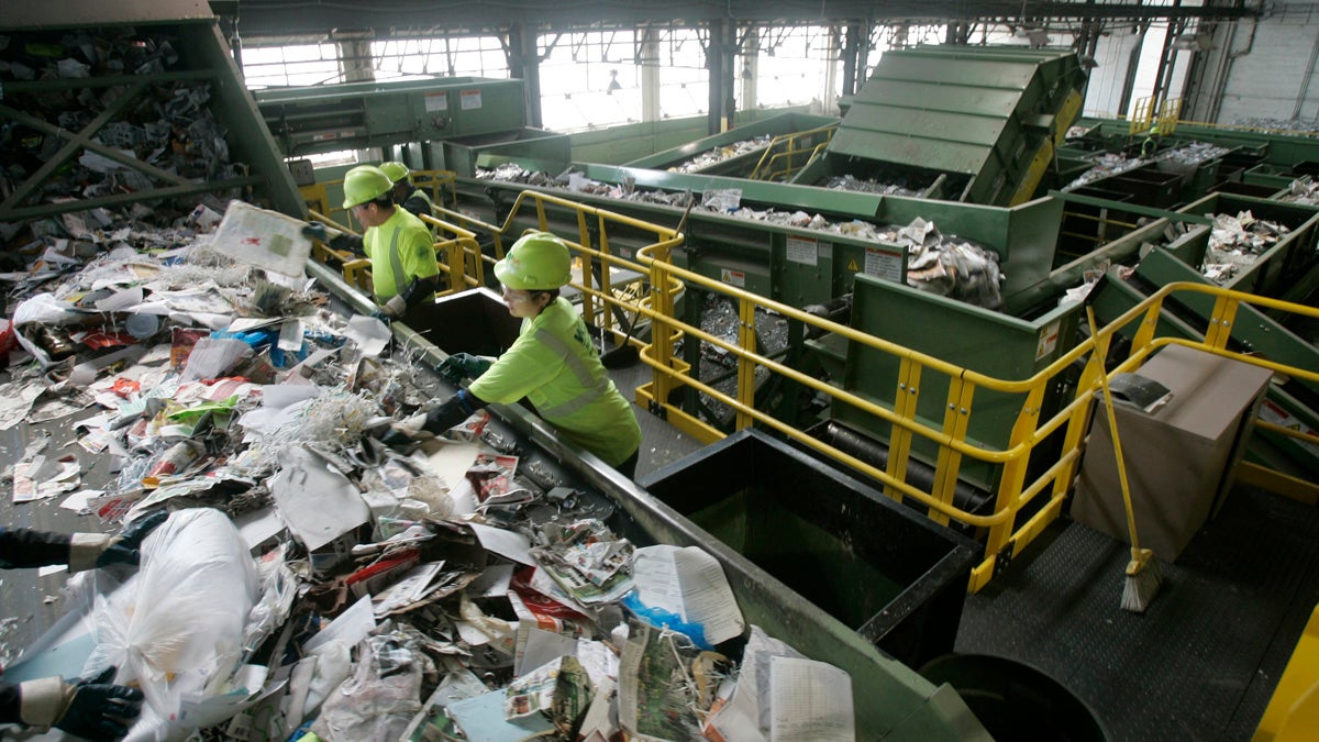Workers sort through paper
