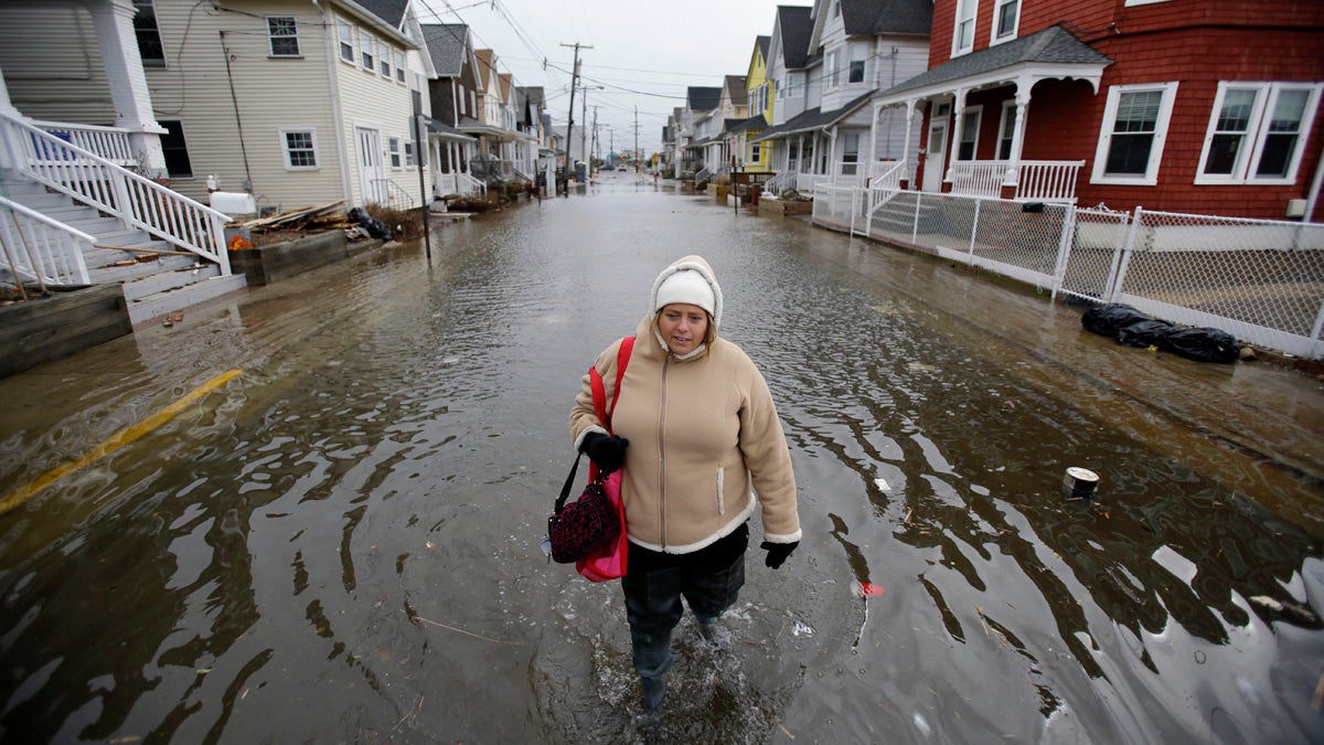  Carol Marelli walks down her flooded street in March 2013, in Sea Bright, New Jersey, after an overnight storm. A new national poll finds that 70 percent of those surveyed believe climate change is an important issue that is affecting areas beyond the coast. (AP file photo) 