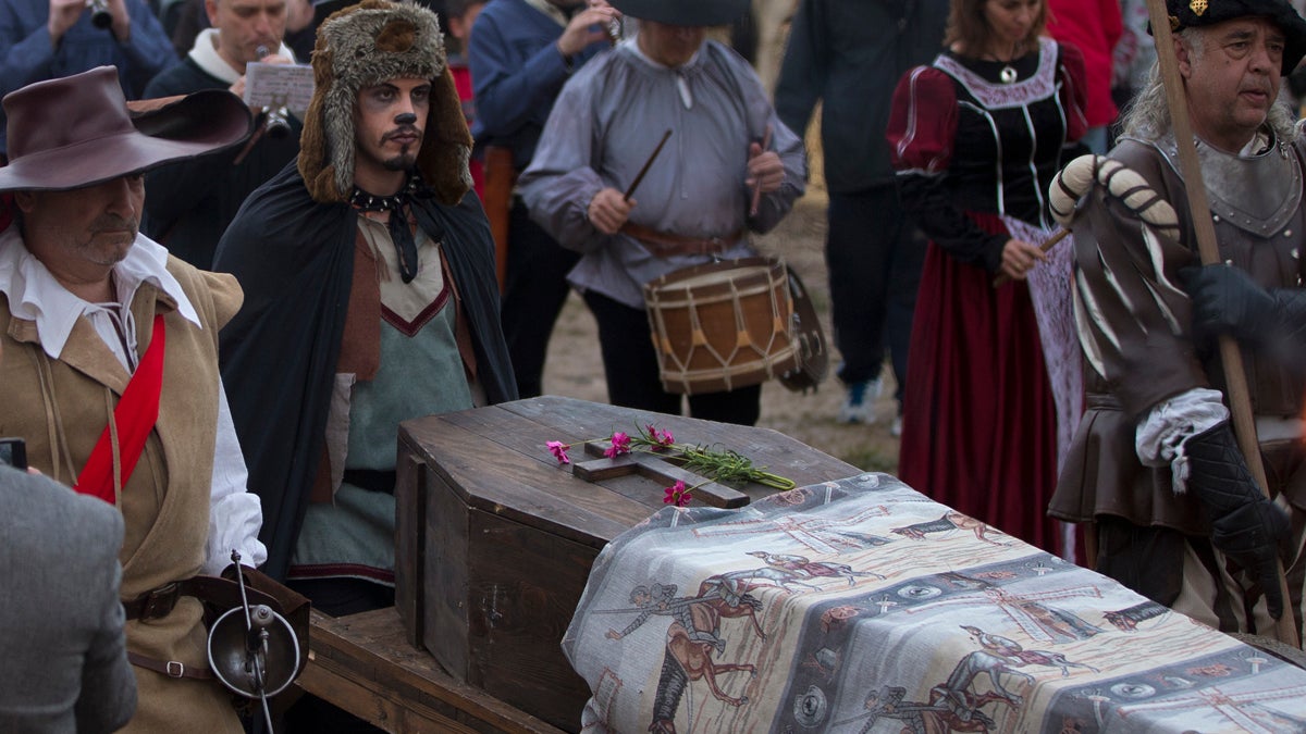 A coffin is wheeled though a street market during a mock funeral for Spanish writer Miguel de Cervantes