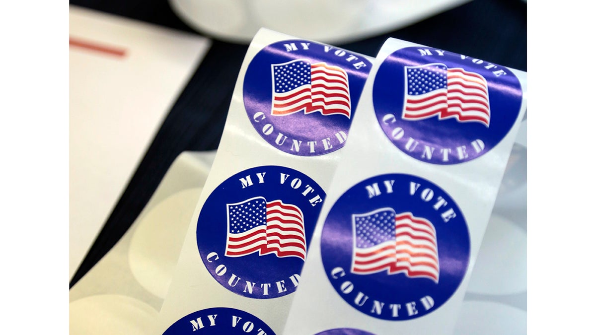 Stickers for voters are seen on a table at a polling station Tuesday