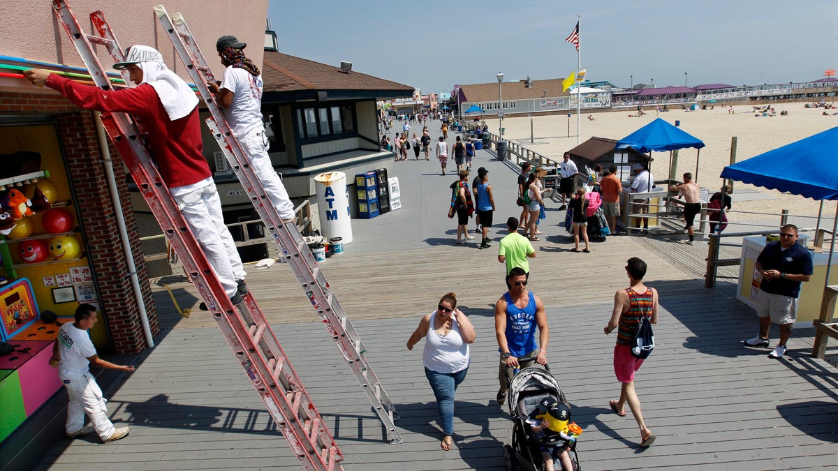 Workers put the finishing touches on fresh paint at an arcade on the boardwalk early Friday in Point Pleasant Beach