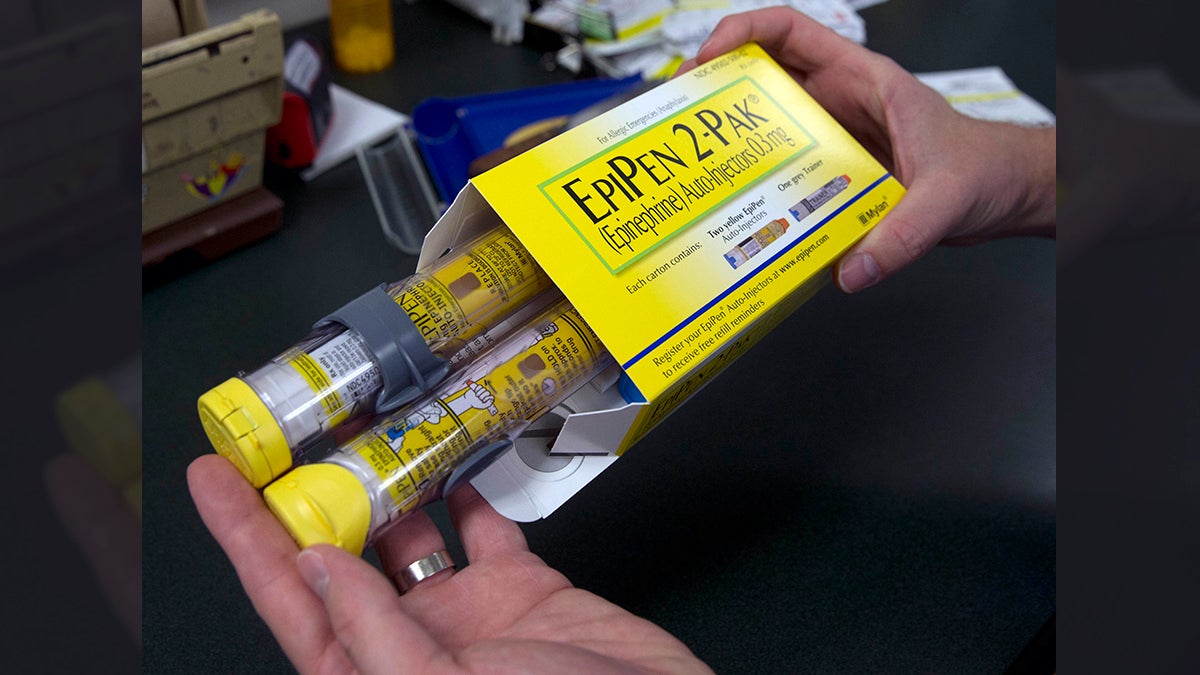 A pharmacist holds a package of EpiPens epinephrine auto-injector