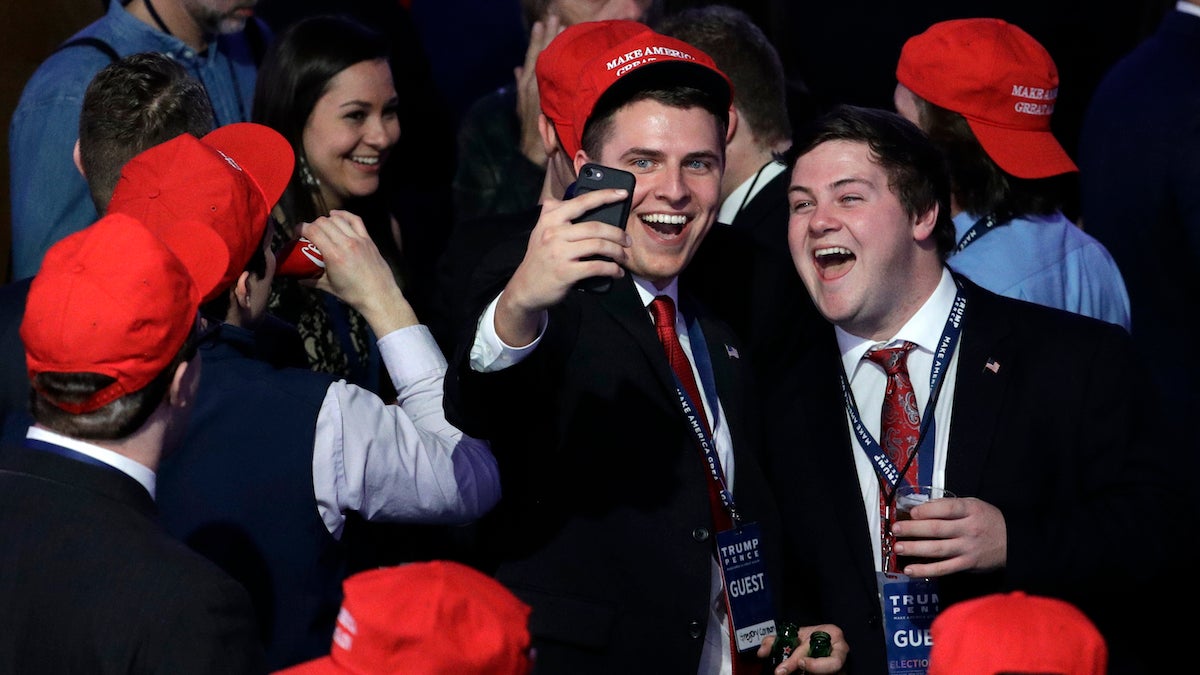 Supporters of Republican presidential candidate Donald Trump take a selfie as they watch the election results during Trump's election night rally