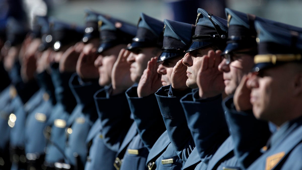 New Jersey State Police officers salute prior to an NFL football game between the New York Jets and the Buffalo Bills Sunday in East Rutherford