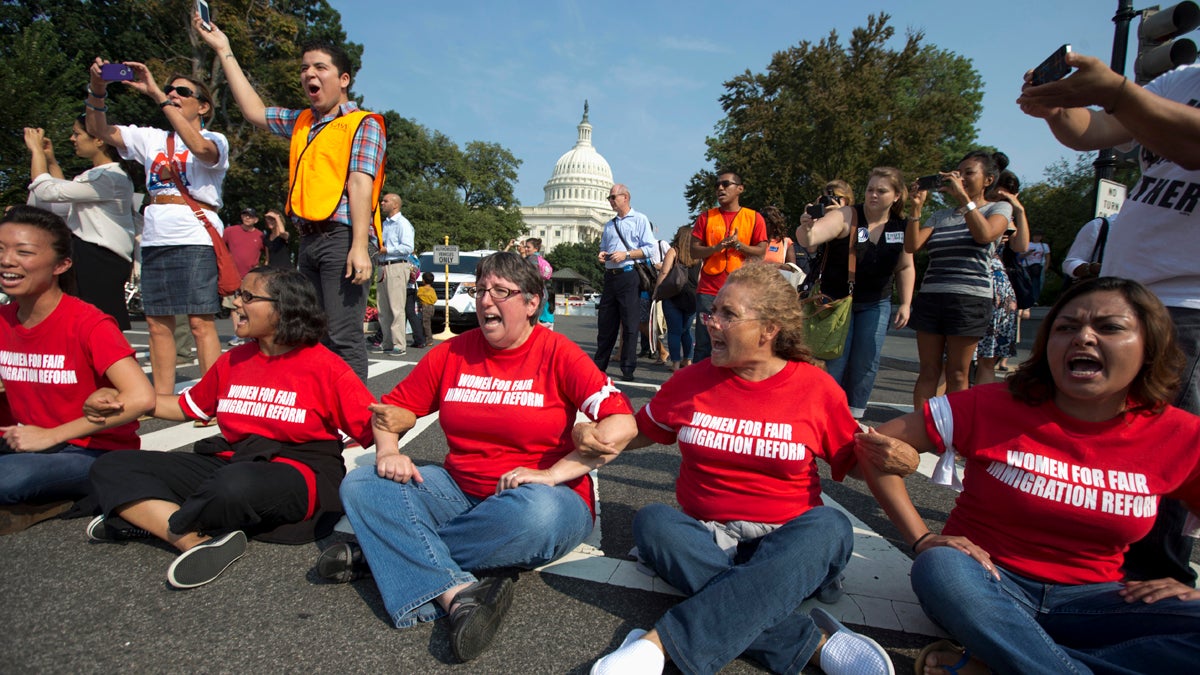 Women link arms and sit in a circle in Washington