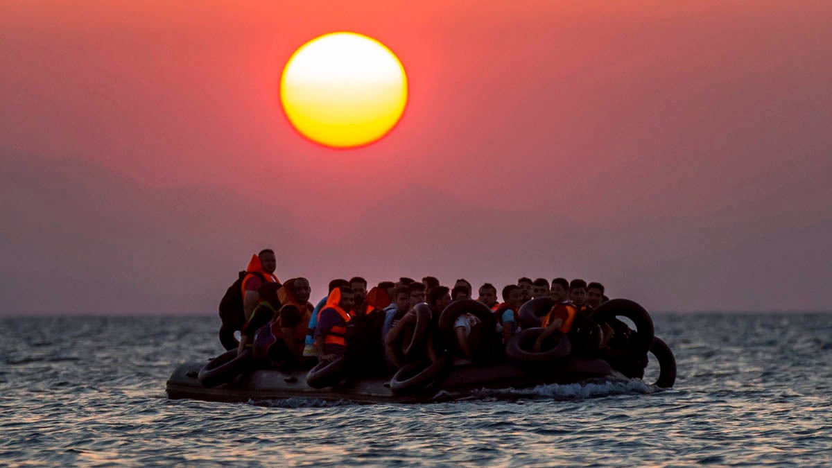  Migrants on a dinghy arrive at the southeastern island of Kos, Greece, after crossing from Turkey in August. While New Jersey Gov. Chris Christie adamantly opposes allowing Syrian refugees to resettle in the Garden State, residents are evenly divided.  (AP file photo) 
