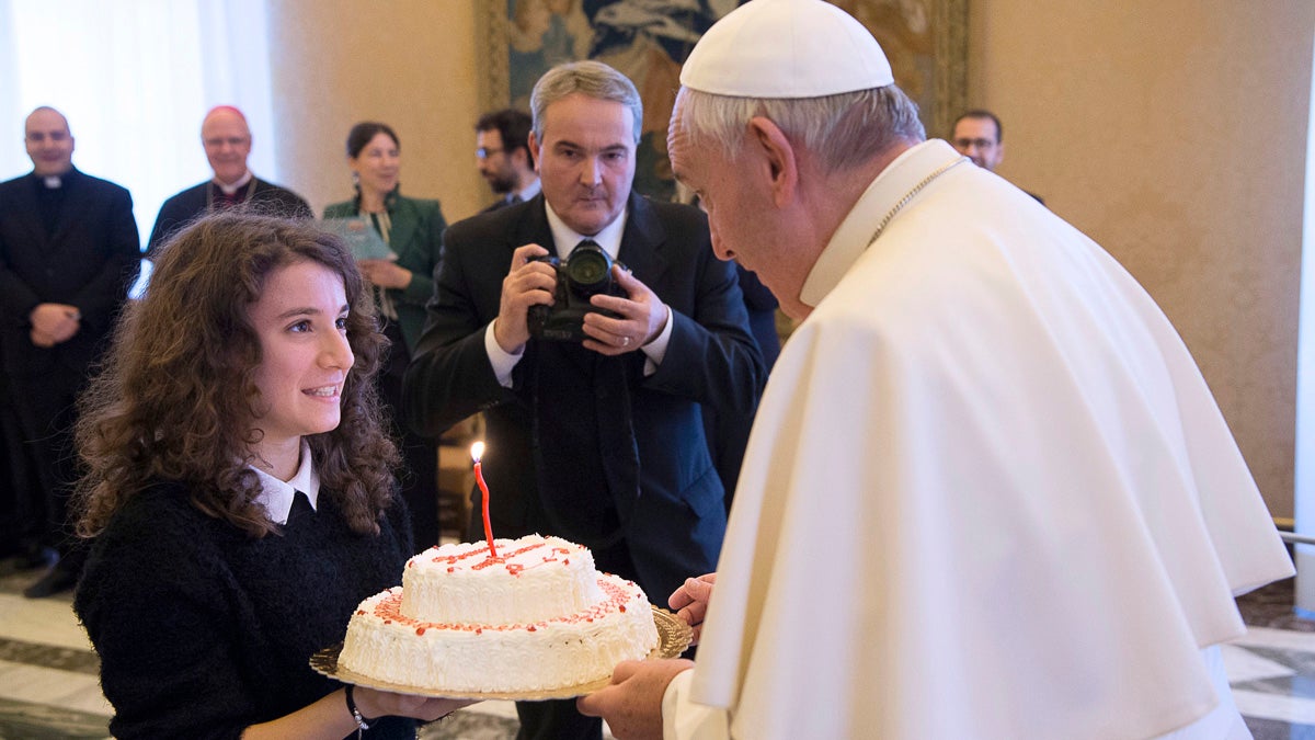  Pope Francis blows a candle on a birthday cake he was presented by a group of youths of the Catholic Action he received during a private audience at the Vatican Thursday. Pope Francis entered his 80th year on Thursday amid hopes among his critics that it will be his last — at least as pope. (L'Osservatore Romano/pool photo via AP) 
