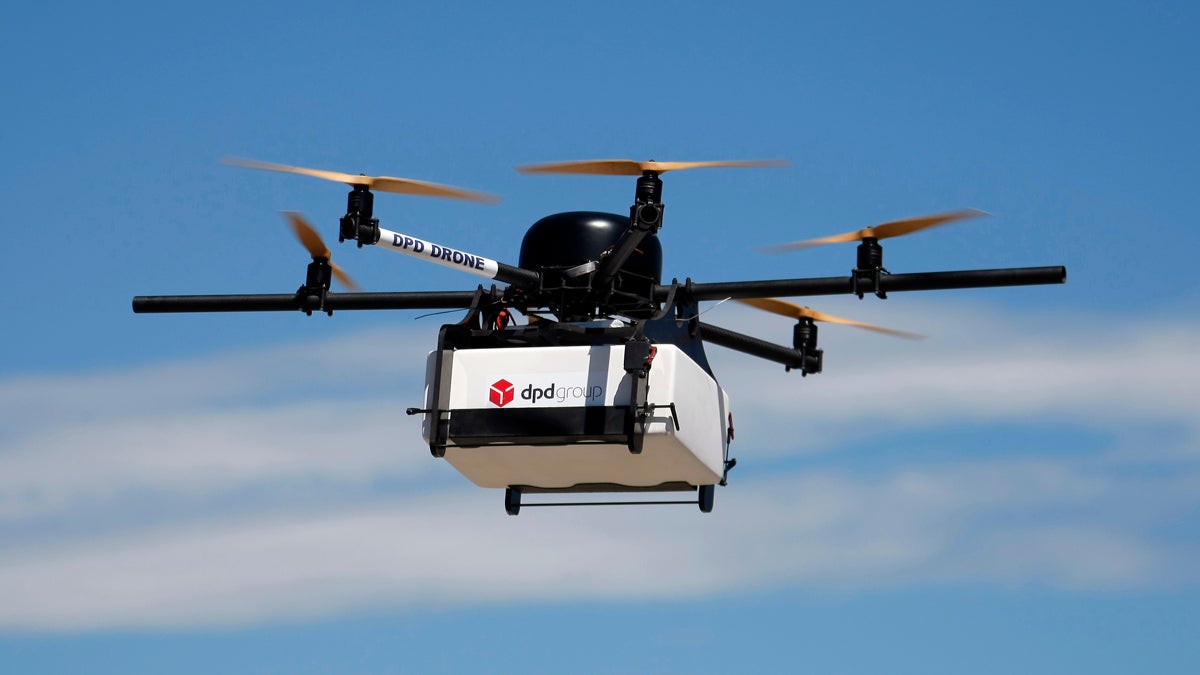  A DPD Geopost prototype drone  carrying a parcel flies during a test flight in Pourrieres, southern France, in June. GeoPost, a package delivery subsidiary of LaPoste, is set to launch a program which will see parcels delivered by drones. The GeoDrone completed its first successful automated flight last September. (AP Photo/Claude Paris) 
