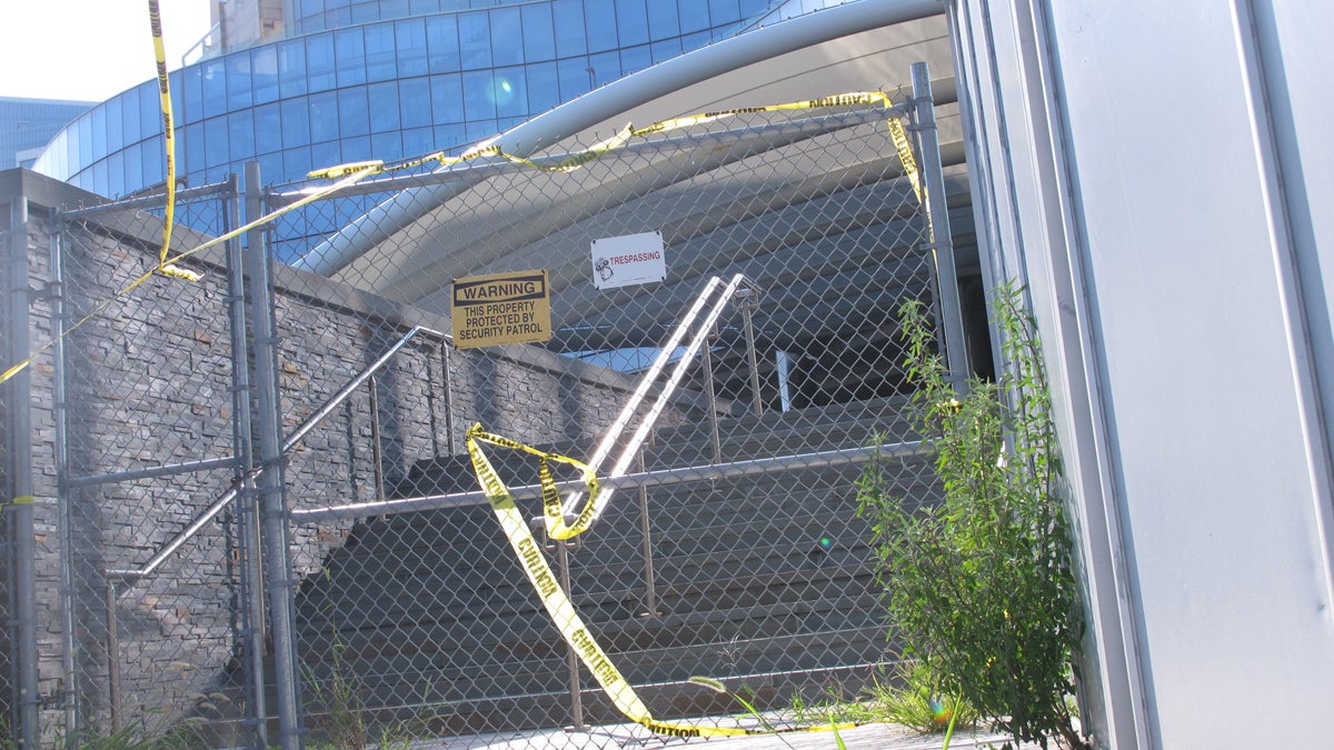  Weeds and caution tape line the entrance to the former Revel casino in Atlantic City, N.J. Friday Aug. 21, 2015. Three windows are missing or smashed at the casino, which has been vacant nearly a year. (AP Photo/Wayne Parry) 