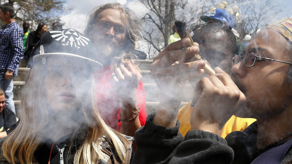 Young party-goers listen to music and smoke marijuana during the annual 4/20 marijuana festival in Denver's downtown Civic Center Park. A new study suggests that long-term marijuana users who smoke several times a week are more likely to suffer from financial and relationship problems than their peers.(AP file photo)