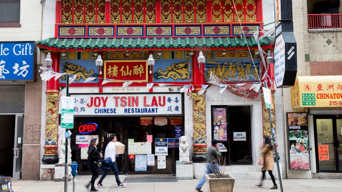  People walk past the Joy Tsin Lau restaurant in the Chinatown neighborhood of Philadelphia. A 'food source' was the root of a food poisoning outbreak that sickened dozens of restaurant patrons in February. (AP file photo) 