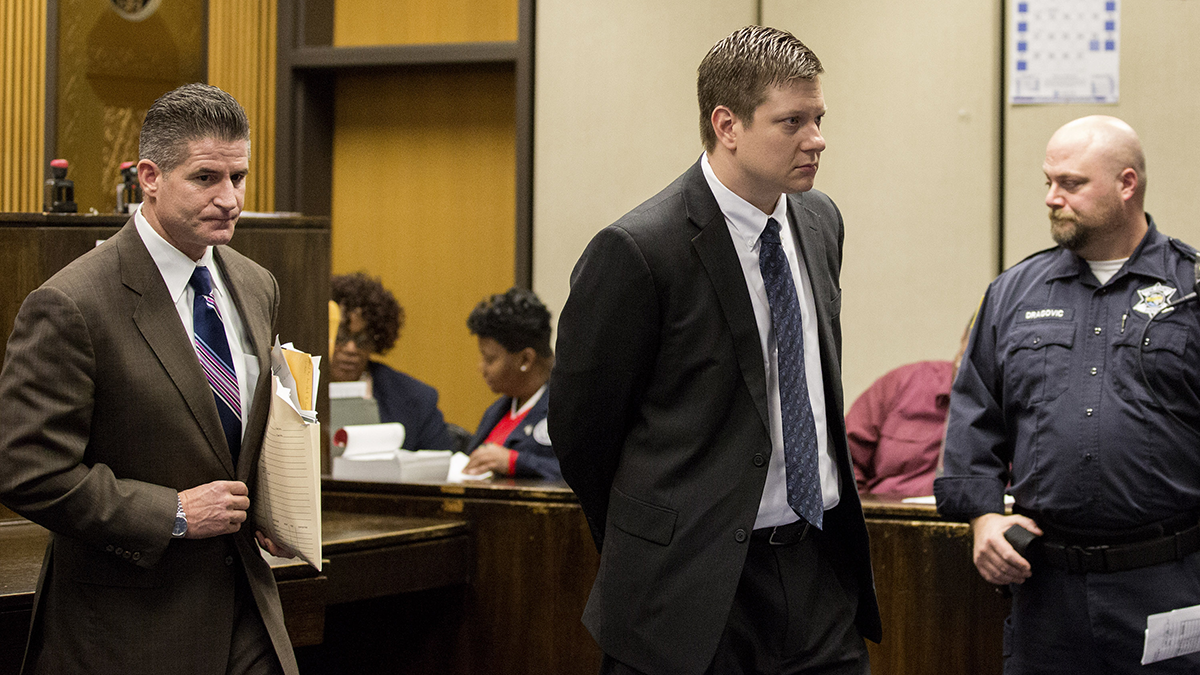  Chicago police Officer Jason Van Dyke, center, leaves the courtroom after a hearing, with his attorney, Daniel Herbert, at the Leighton Criminal Court Building in Chicago, Friday, Dec. 18, 2015. It was Van Dyke’s first appearance in court since a grand jury indicted him on Wednesday, Dec. 16. He faces six counts of first-degree murder and one of official misconduct in the 2014 shooting death of 17-year-old Laquan McDonald. (Zbigniew Bzdak/Chicago Tribune via AP, Pool) 