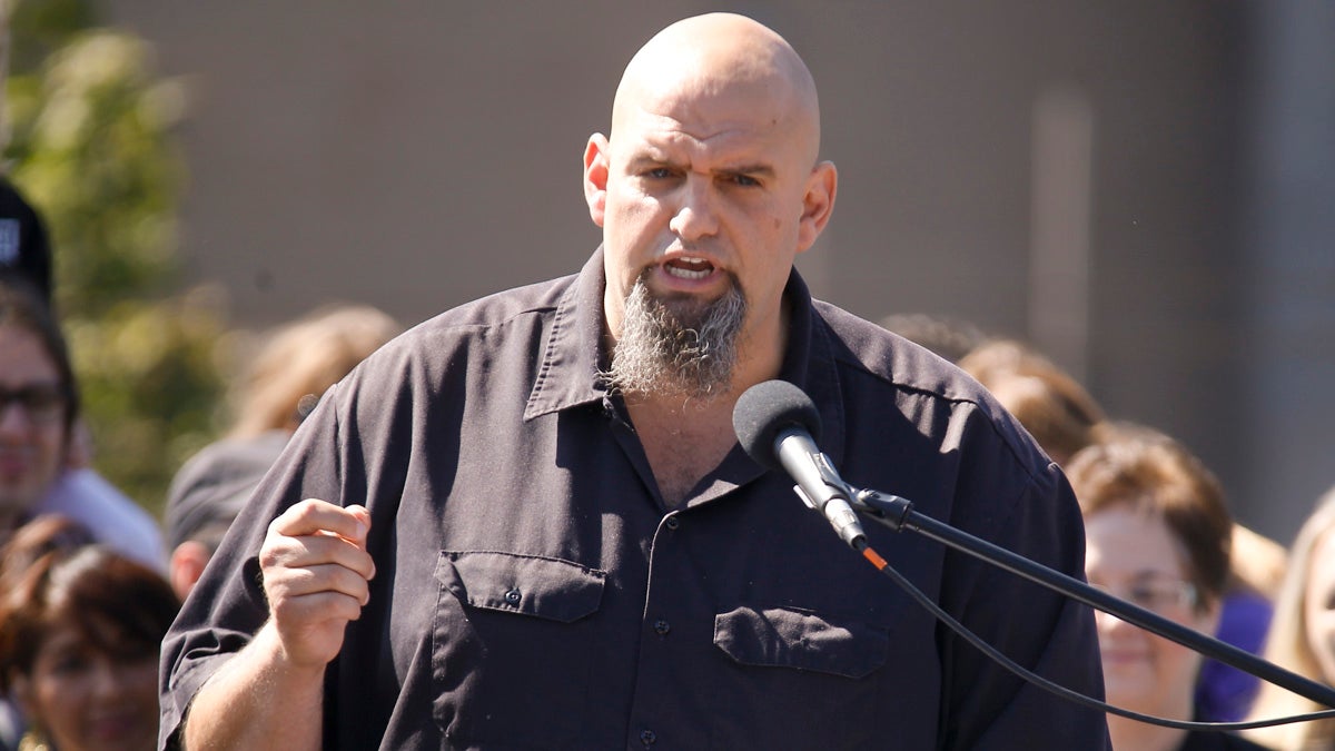 John Fetterman, the mayor of Braddock, Pa. addresses a crowd on the roof of his home during his announcement that he is running for the U.S. Senate on Monday, Sept. 14, 2015 in Braddock, Pa.(AP Photo/Keith Srakocic)