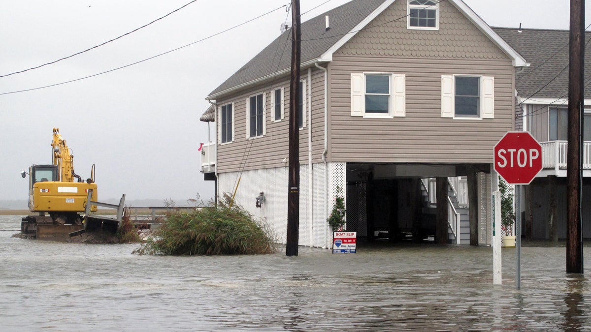  Flood waters enveloped this neighborhood in the Strathmere section of Upper Township, New Jersey, Friday. Despite forecasts showing the impending Hurricane Joaquin may move out to sea and not directly strike New Jersey, crews along the shore were nonetheless taking precautions against a wind and rainstorm. (AP Photo/Wayne Parry) 