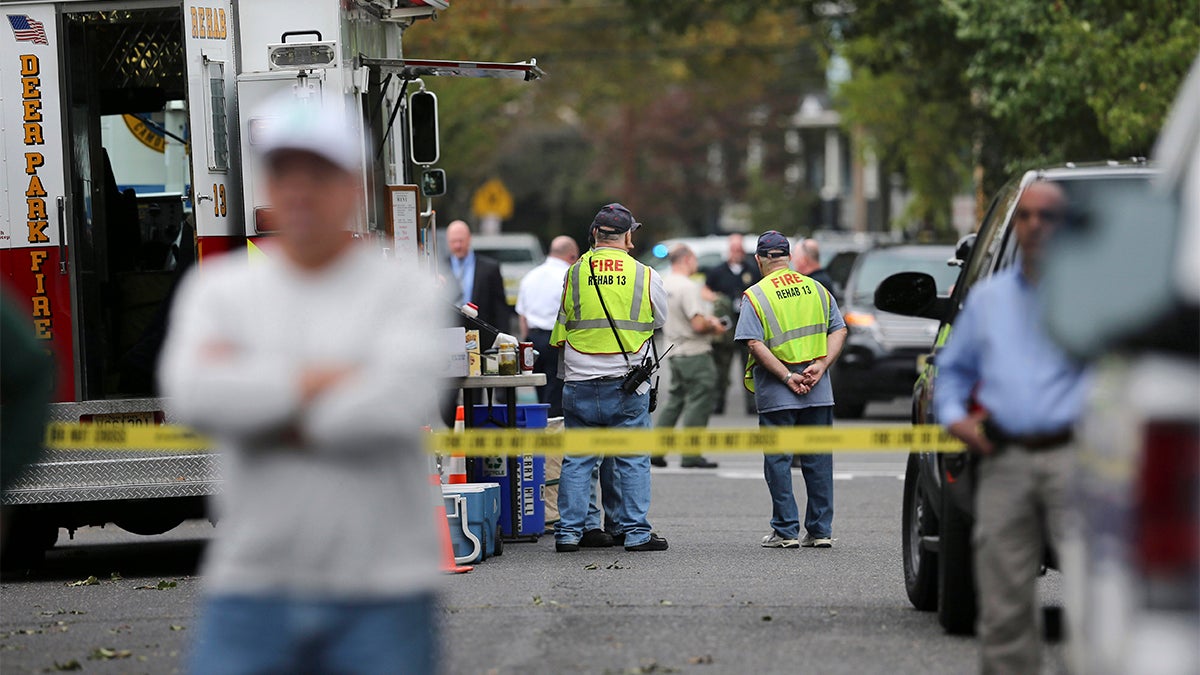 Officials gather near a small apartment building where 3-year-old  Brendan Creato was reported missing and found dead three hours later in woods several blocks from the home in October in Haddon Township, N.J. (AP Photo/Mel Evans) 