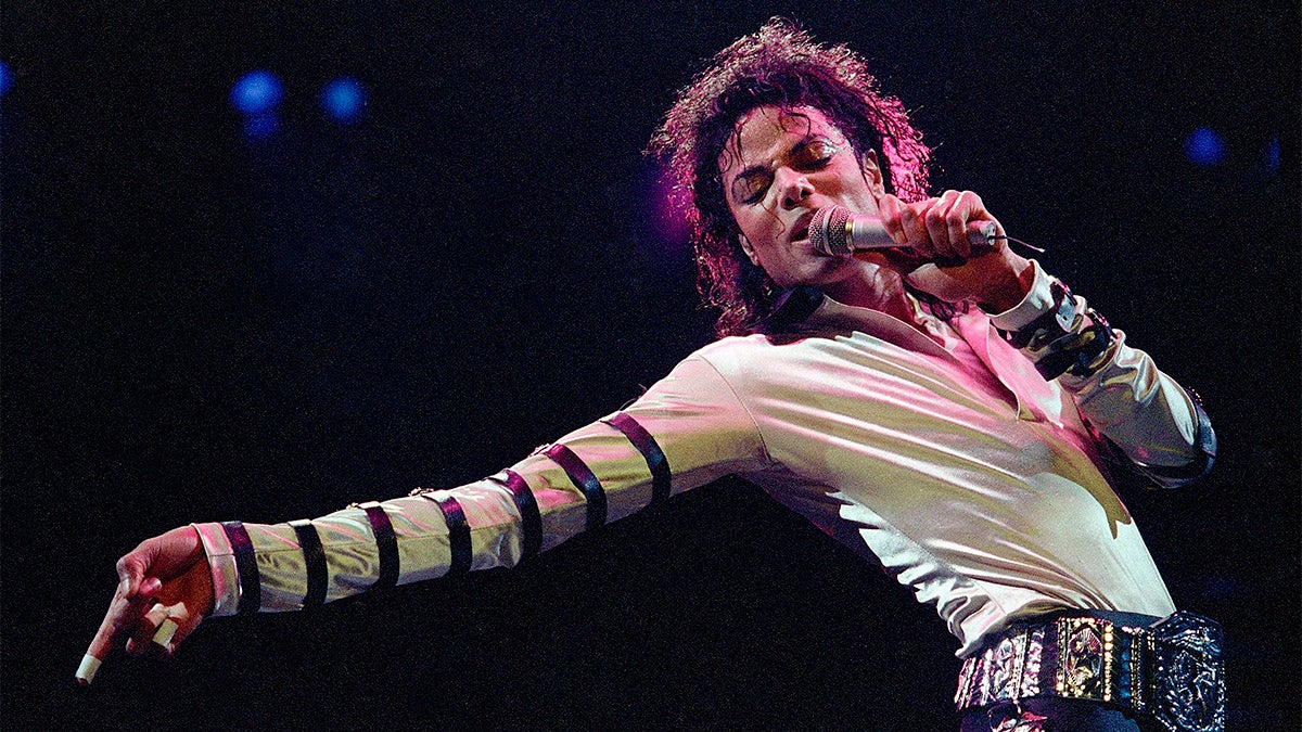  In this Feb. 24, 1988 file photo, Michael Jackson leans, points and sings, dances and struts during the opening performance of his 13-city U.S. tour, in Kansas City, Mo. (AP Photo/Cliff Schiappa, File) 
