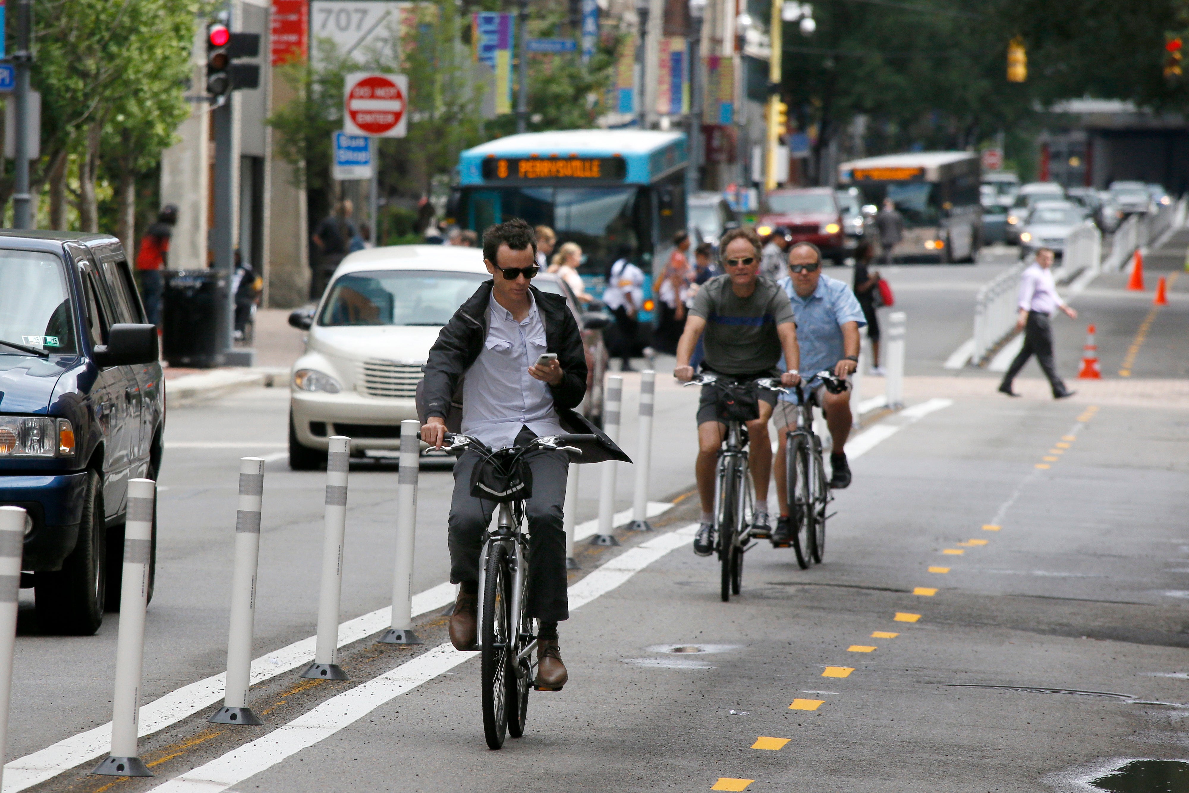 Bicyclists pedal on a bicycle-only lane on Penn Avenue in downtown Pittsburgh. (AP Photo/Keith Srakocic)