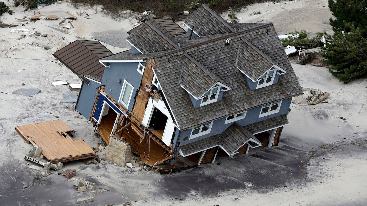 This aerial photo shows a collapsed house along the central Jersey Shore coast in October 2012. (AP Photo/Mike Groll)