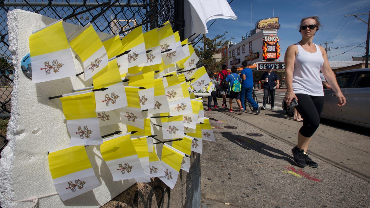 Vendors sell souvenir Vatican flags in South Philadelphia prior to Pope Francis' September visit to the city. Organizers of the Democratic National Committee Convention are finalizing  security and vending details for the event in July at the Pennsylvania Convention Center in Philadelphia. (AP Photo/Laurence Kesterson)